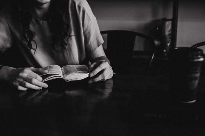 A young woman reading a Bible.