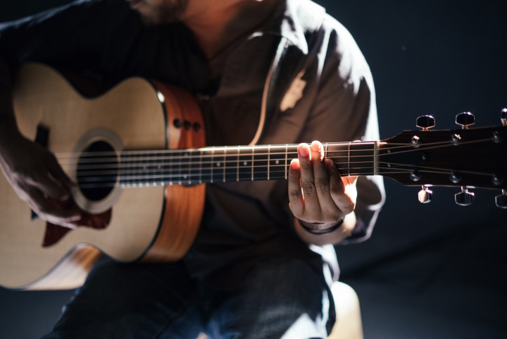 A person playing a guitar.