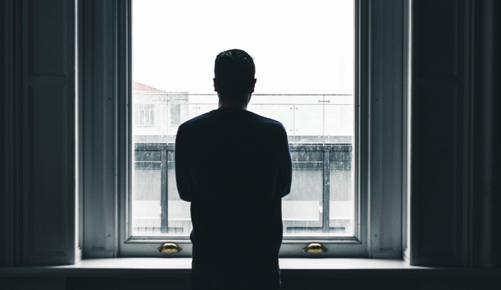 A man looking out a window.