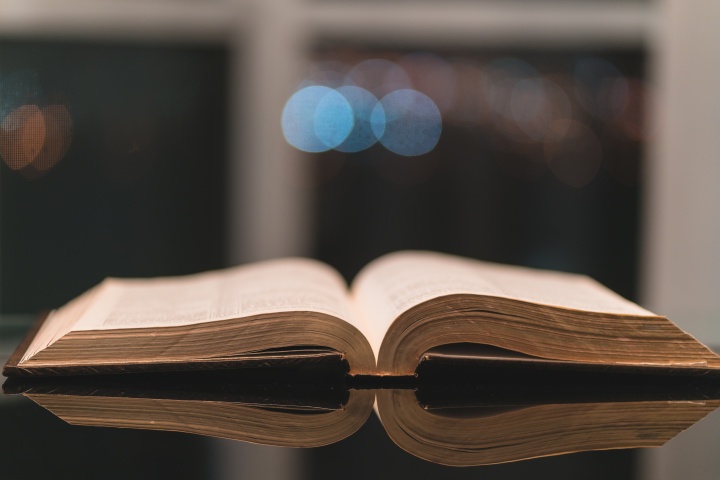 An open Bible laying on a table.