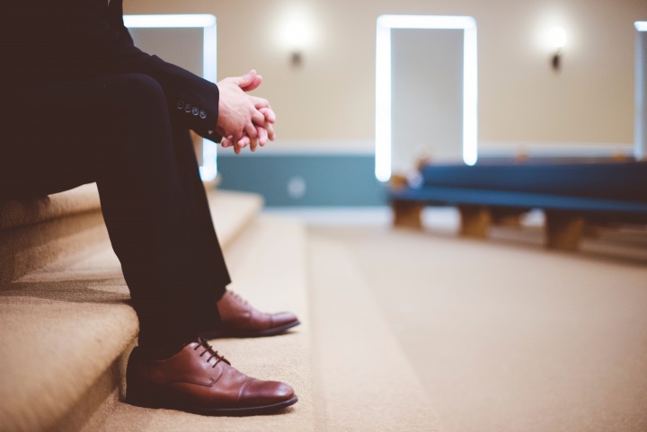 A man sitting inside a church.