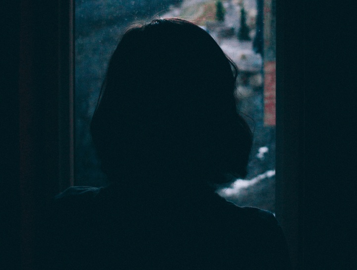 A woman looking out a window.