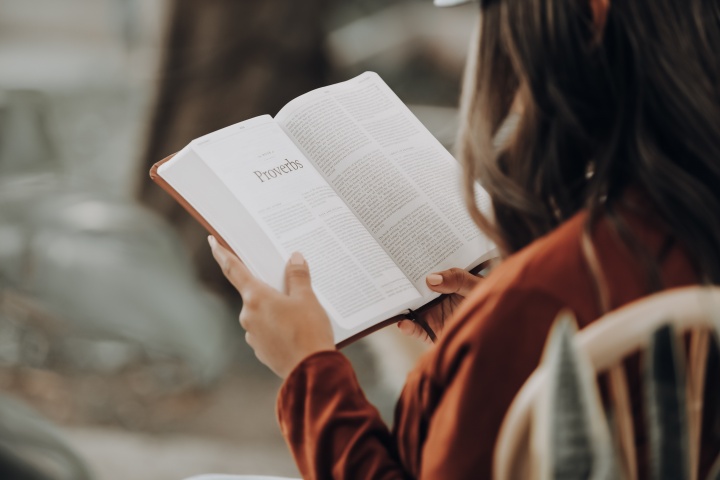 A woman reading a Bible.