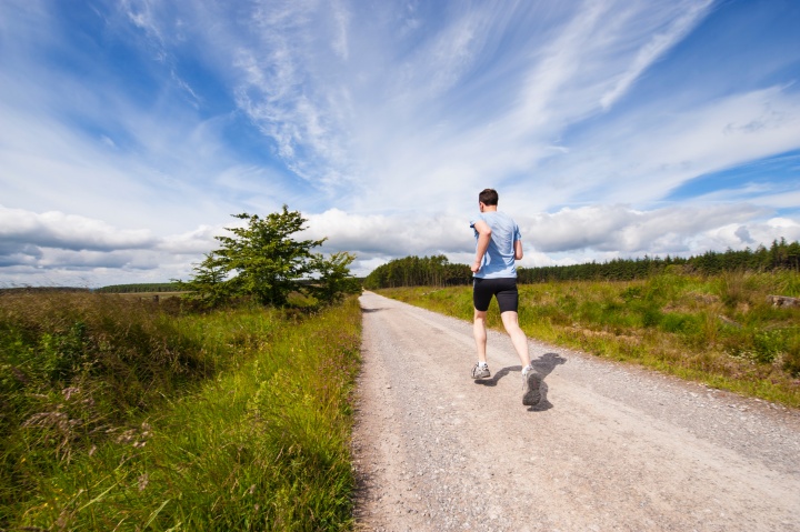 Man running on road.