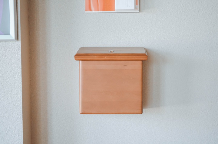 A box attached to the wall where one could drop in money at a church.