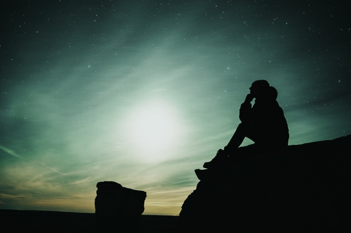 A man sitting on a rock.