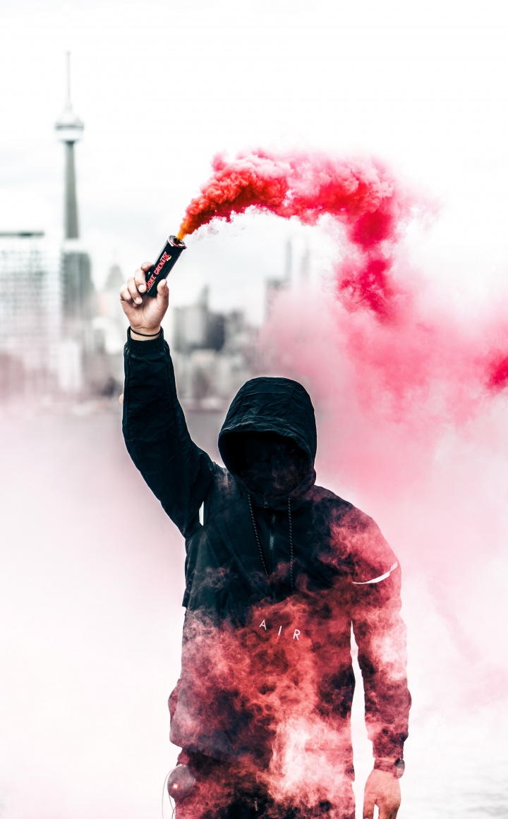 Protester with can of smoke