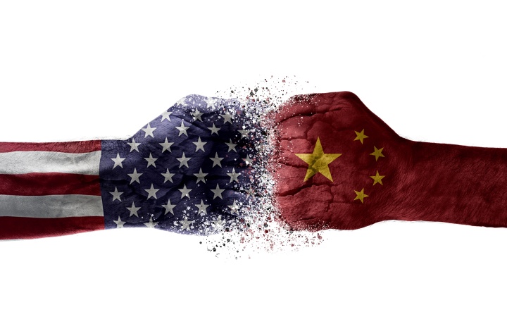 An artist illustration of two fists colliding with superimposed images of American and Chinese flags of fists.