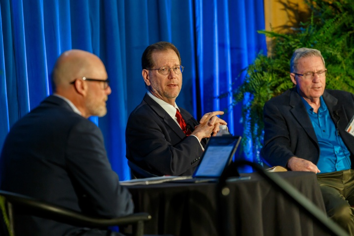 Three men giving a panel presentation