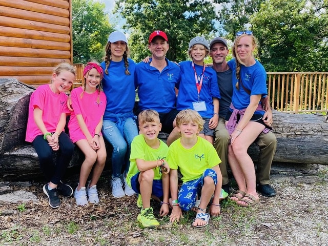 a group of campers and staff wearing camp shirts outdoors