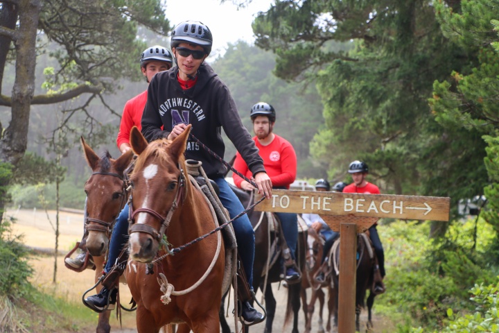 a group of teenagers riding horses