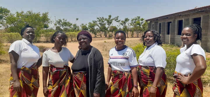 a group of women wearing matching skirts 