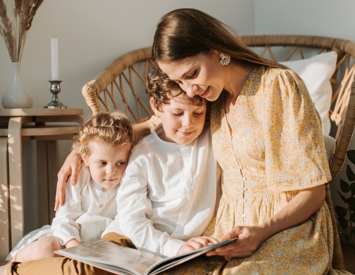 a woman reading to two children