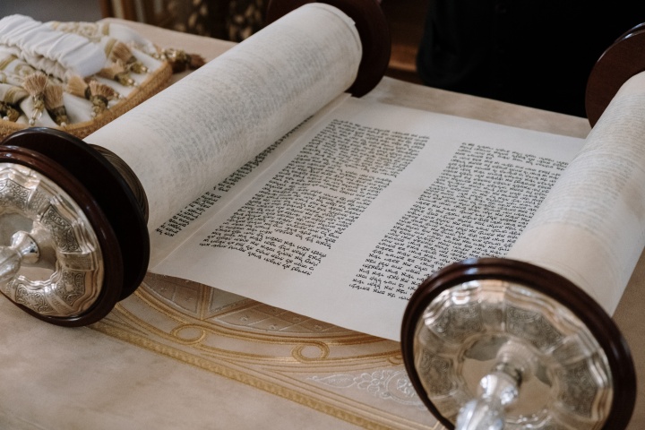 a Hebrew scroll rolled partially open to reveal text