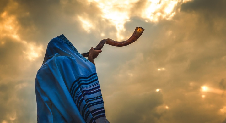 A person blowing a shofar.