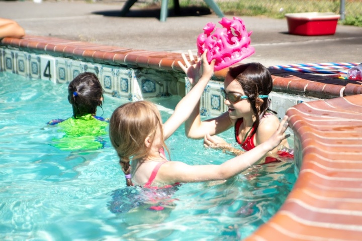 some girls playing in the swimming pool