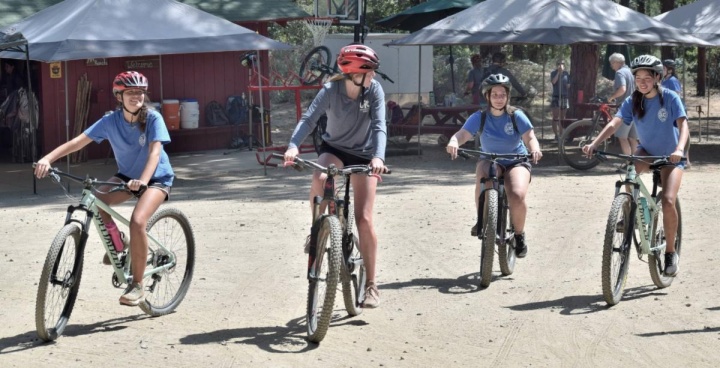 four teenage girls riding bicycles