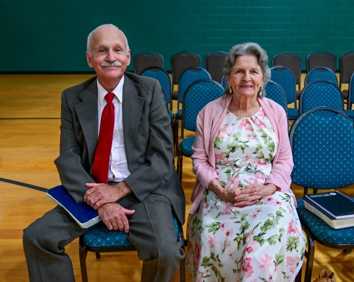 an older couple seated indoors