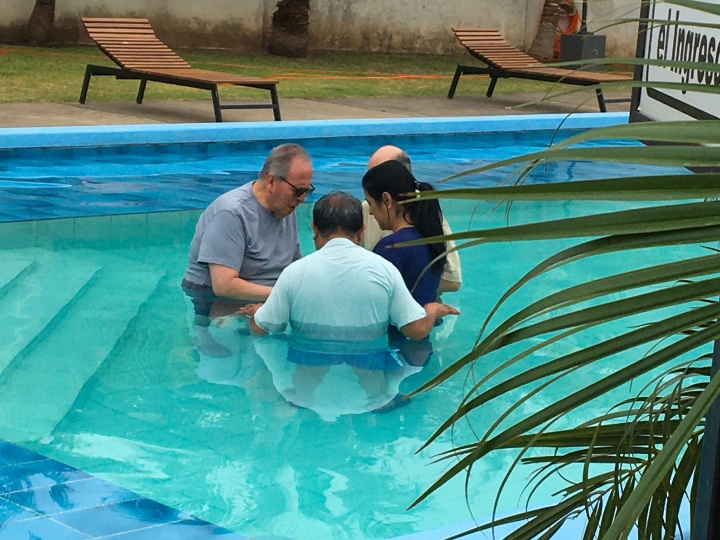 four people in a swimming pool