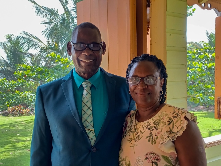 a smiling couple wearing church attire