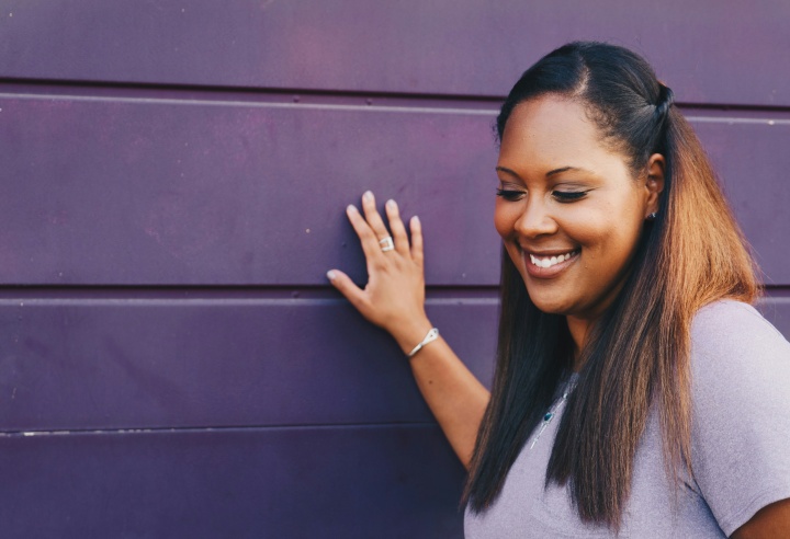 woman touching a purple wall