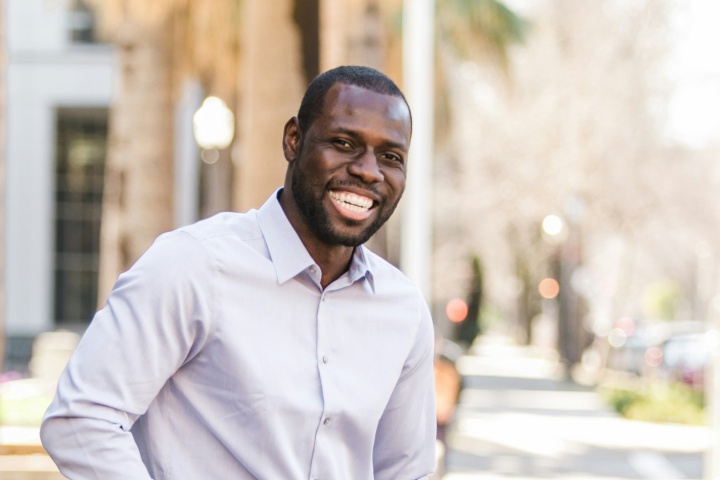 smiling man wearing white shirt