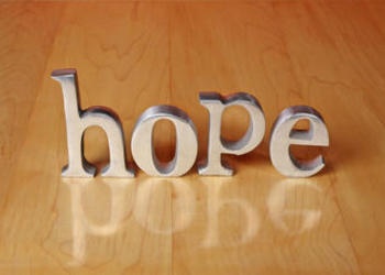 The letter HOPE on a table.