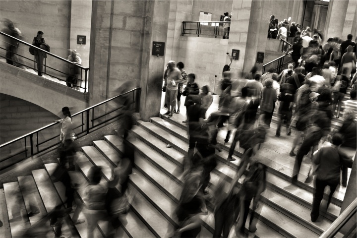 A blur of people walking in a building.