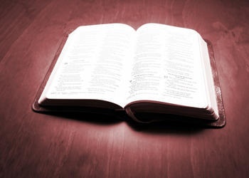 A open Bible laying on a table.