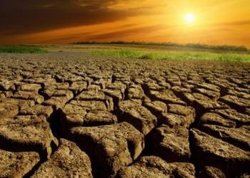 Dry cracked land with sunset in back - Drought Conditions Reach Crisis Levels