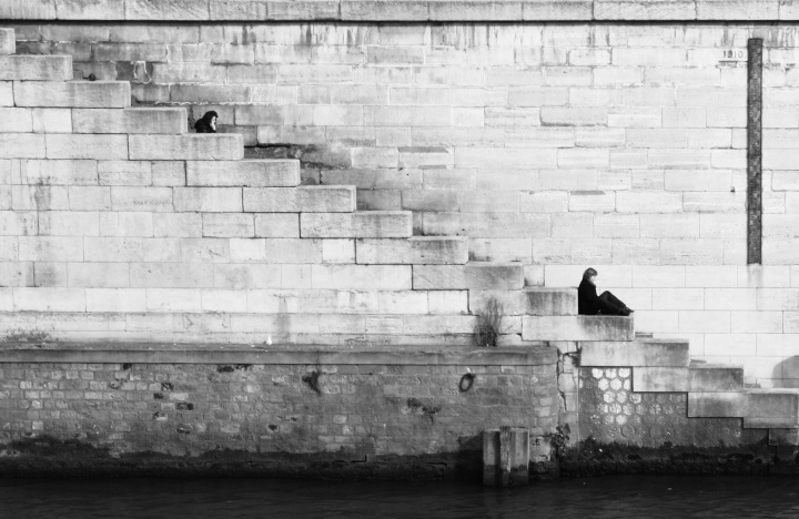 A person sitting on old stairs.
