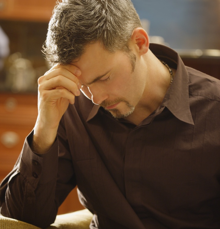 A man praying over his Bible