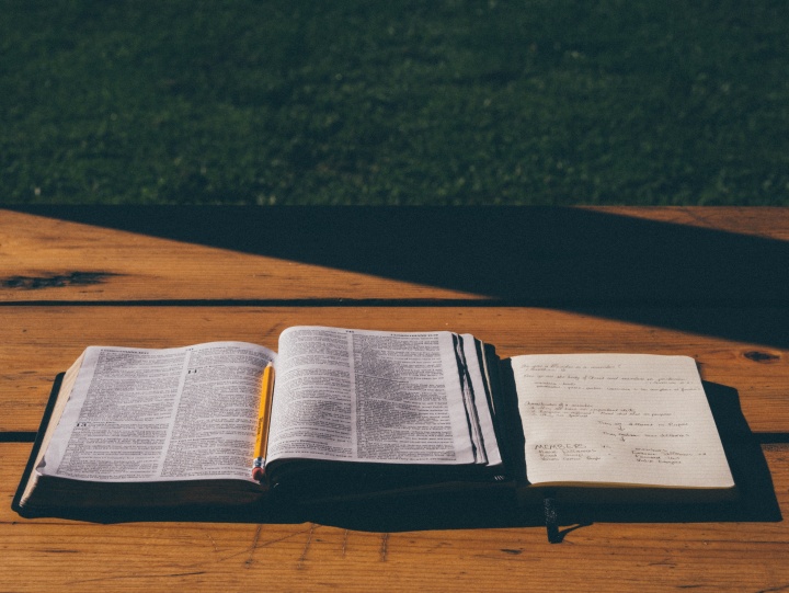 An open Bible on top of a table.