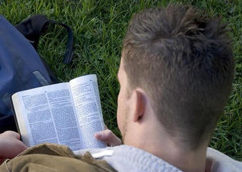 A young man reading the Bible.