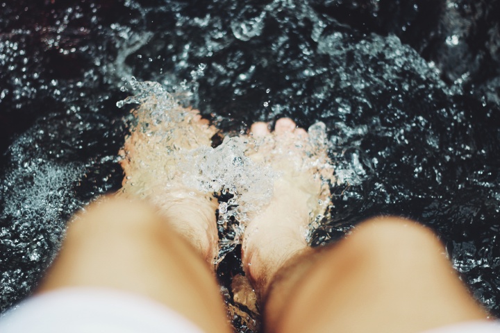 A person's feet in water.