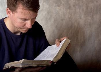 Man reading a Bible.