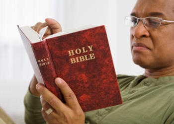 A man reading a Bible.