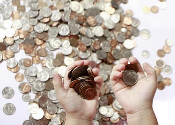 child's hands holding coins