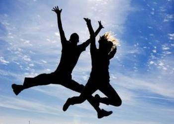 two people jumping in the air