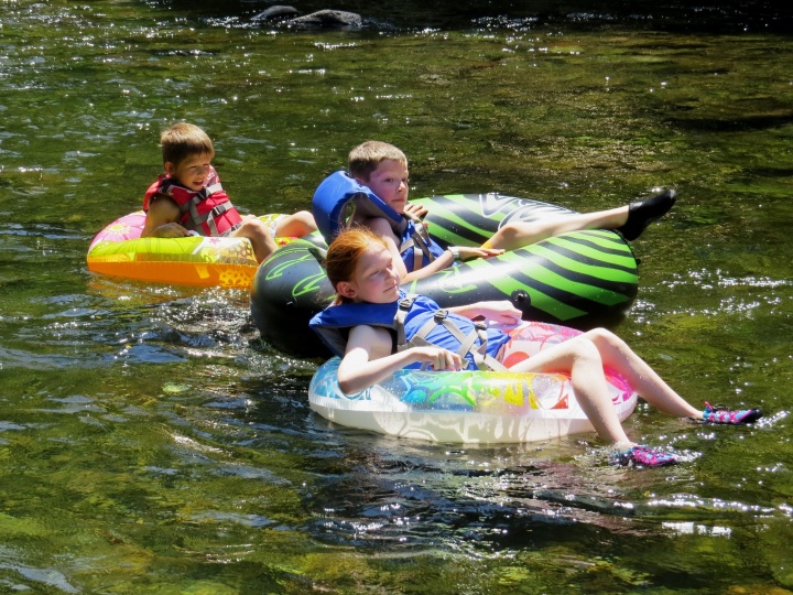 Campers on a river float. 