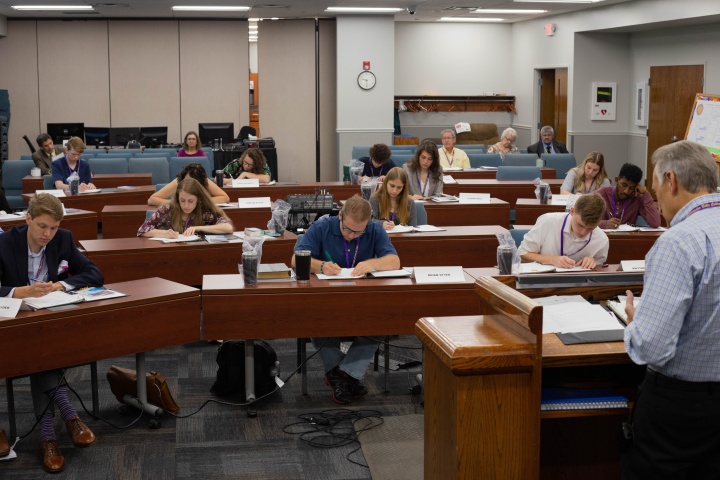 The 17 new students fill out information sheets during ABC registrar Steve Myers’ presentation during orientation.