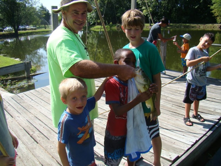 Campers fishing with staff.