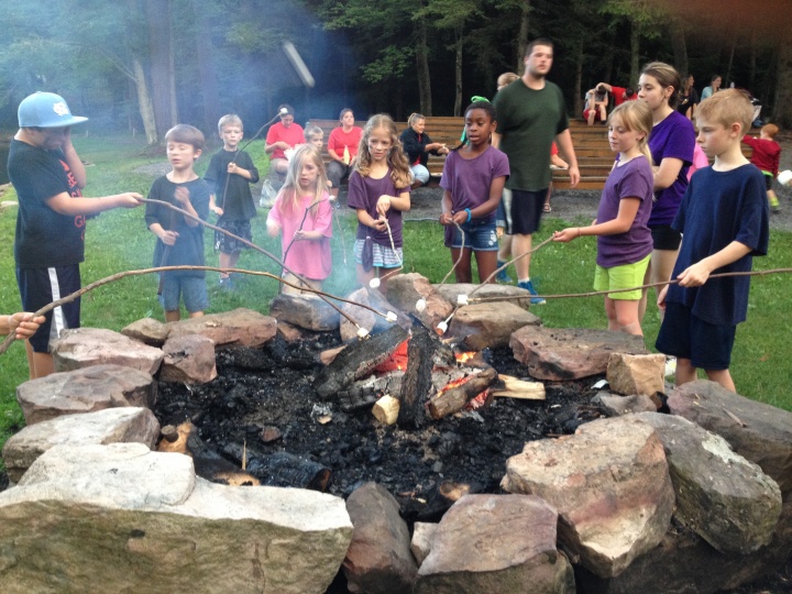 Campers roasting marshmallows. 
