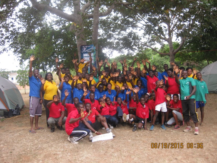 Campers and staff pose and wave at the camera. 