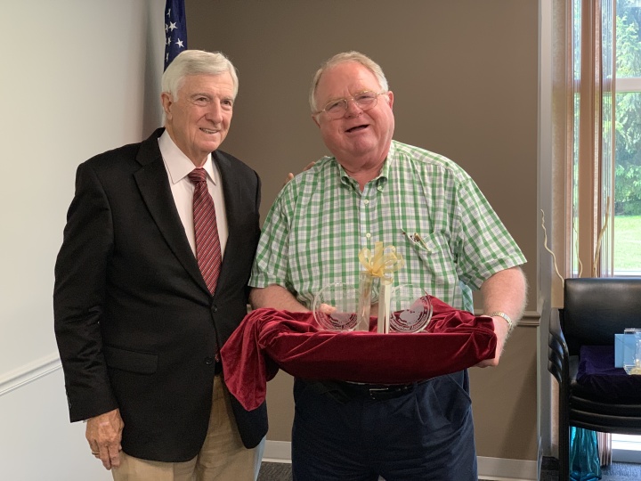 Dr. Ward presents Mr. Seelig with a gift in honor of his service as corporate secretary.