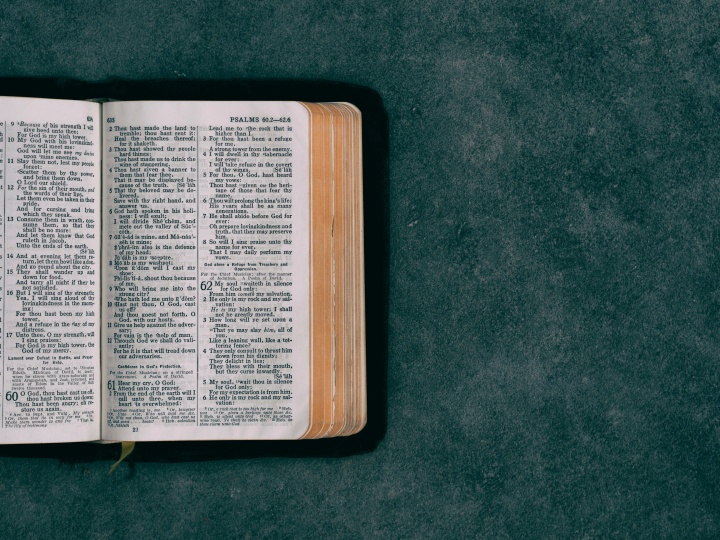 an open Bible on a blue background