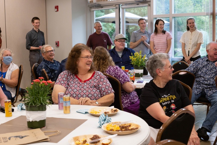 Employees and their families watch the raffle drawing after lunch.