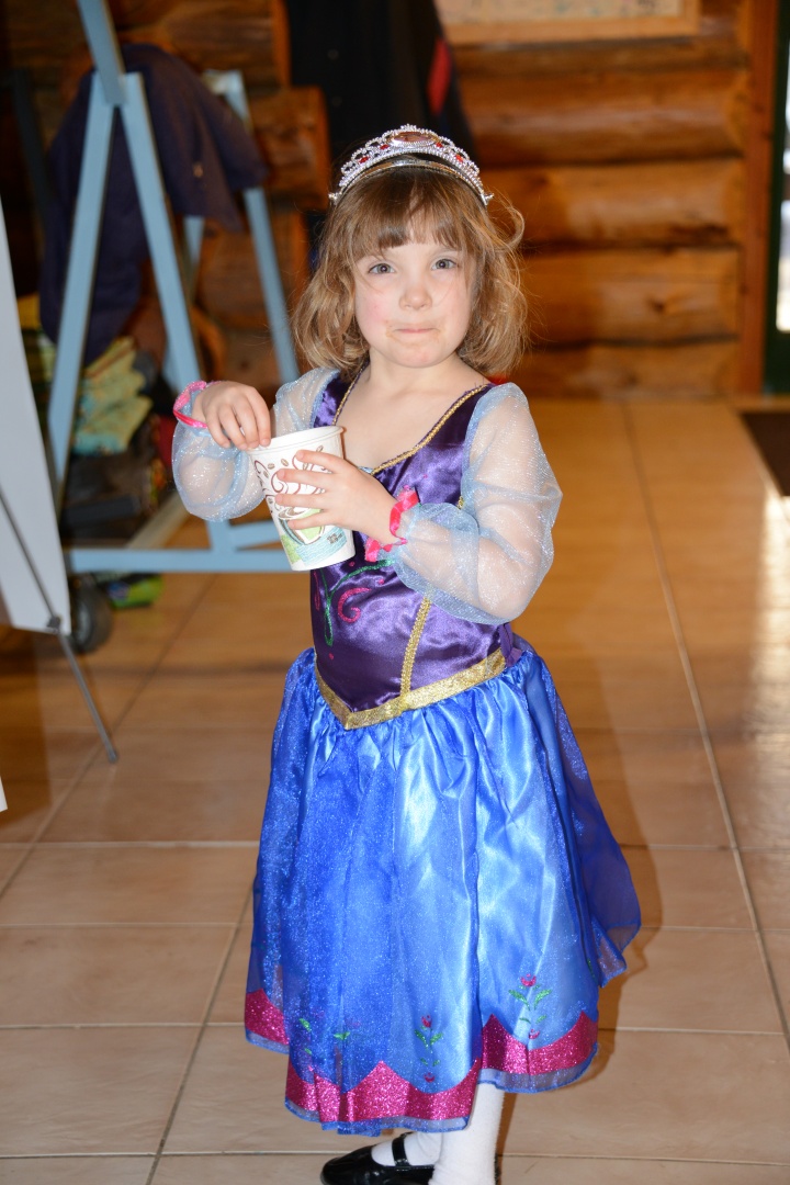 Isabelle White dressed as a TV princess enjoying a hot chocolate drink.