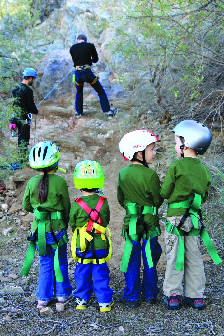 Campers getting ready to go rock climbing. 