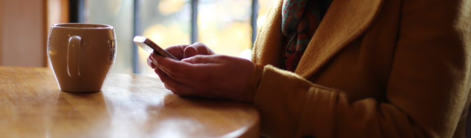 A woman using her smartphone to view website or check email.